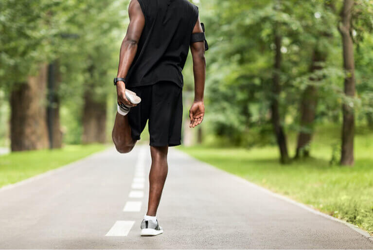 Jogger stretching his leg