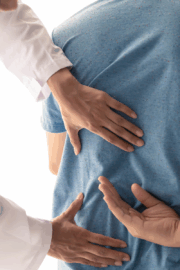 Physical therapist demonstrating how to protect your back while lifting