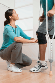 Physical therapist helping patient with joint replacement recovery exercises at Reform PT clinic.