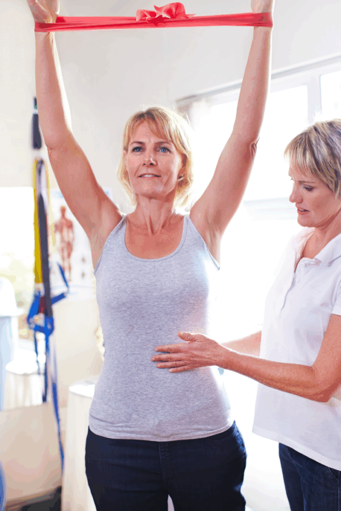 Physical therapist guiding patient through a stretching warm-up
