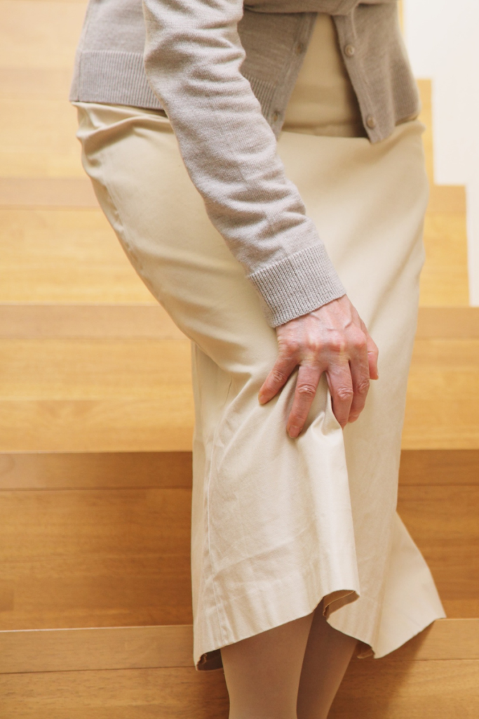 Person walking outside in winter using warm layers to reduce cold weather joint pain.