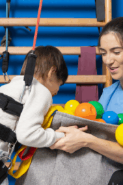 Parent gently massaging their child’s calf while the child sits on the couch.