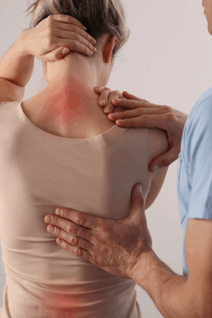 Physical therapist guiding a patient to stop painful movement.