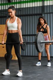 Athlete squatting with proper form in CrossFit gym