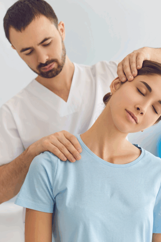 Physical therapist assessing a patient’s neck during first visit