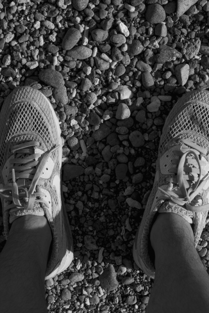 Worn-out running shoes on Maine pavement