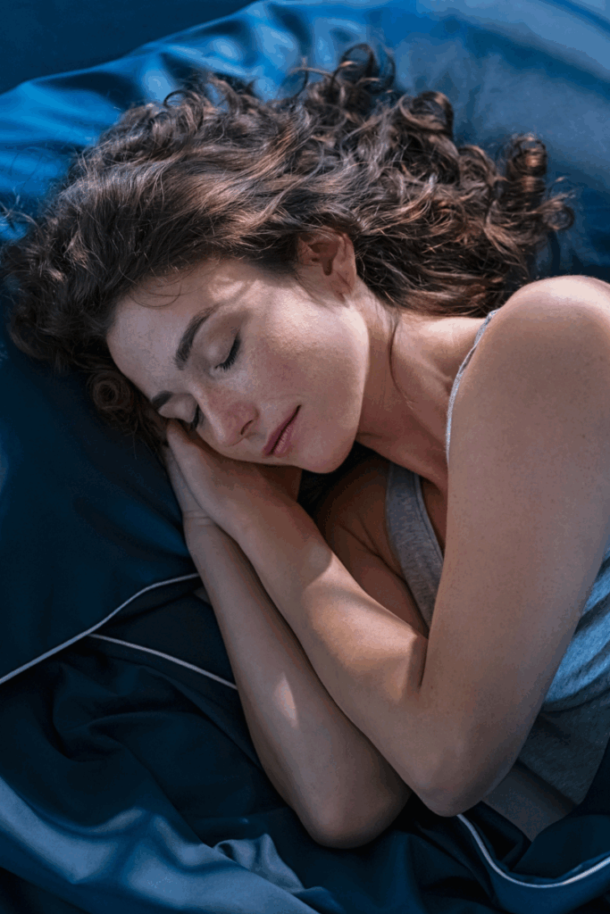 Woman sleeping on her side with pillow between knees