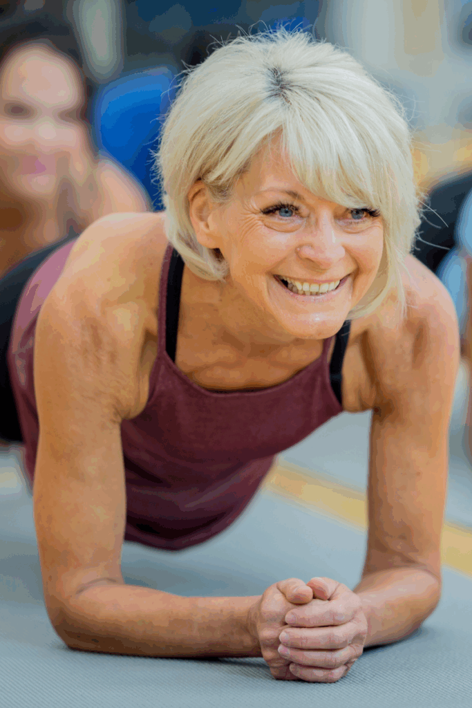 PT guiding patient through plank exercise in Southern Maine clinic
