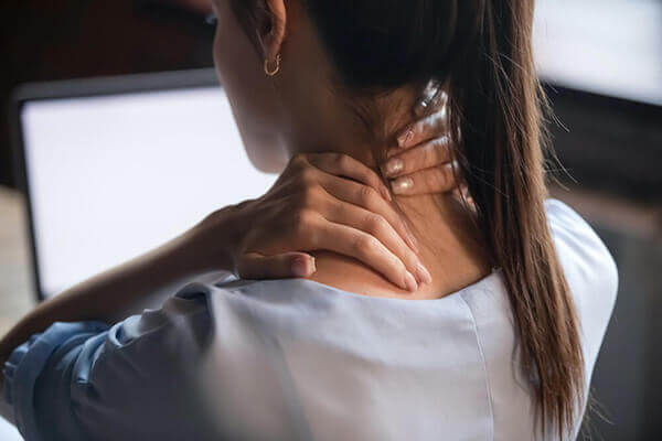 Woman holding her neck neck pain reform physical therapy 