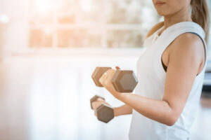 Female athlete performing strength training during sports rehabilitation at Reform Physical Therapy